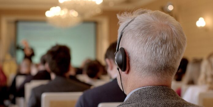 Businessperson with headphones at a meeting