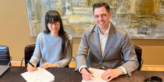 Company representatives making the acquisition of Translated By Us official