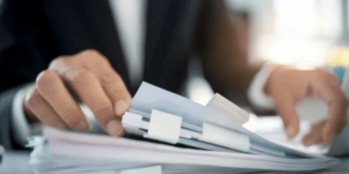 Man viewing documents on his desk