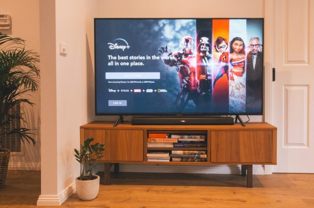 Breaking Down Disney’s Localization Plans across Asia black flat screen tv turned on on brown wooden tv rack