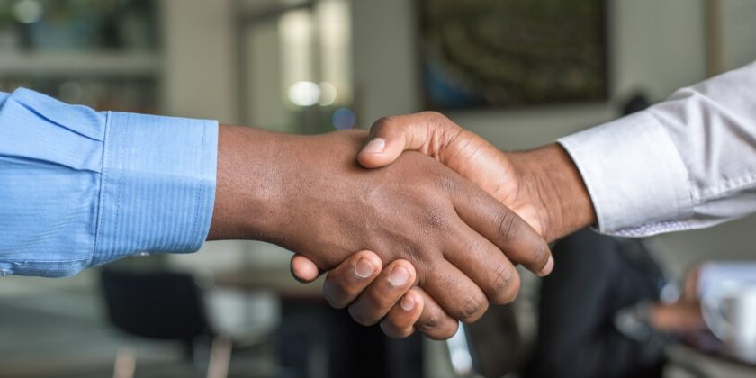 TAUS and Intento Announce New Partnership two people shaking hands